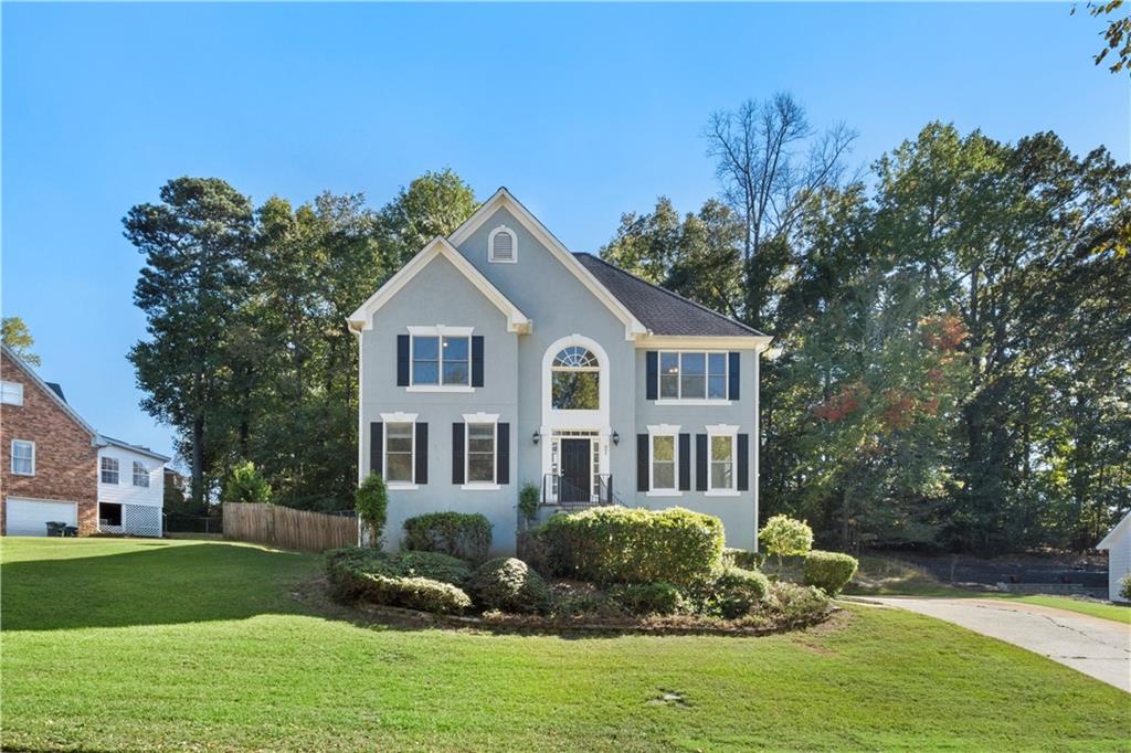 a front view of a house with a garden