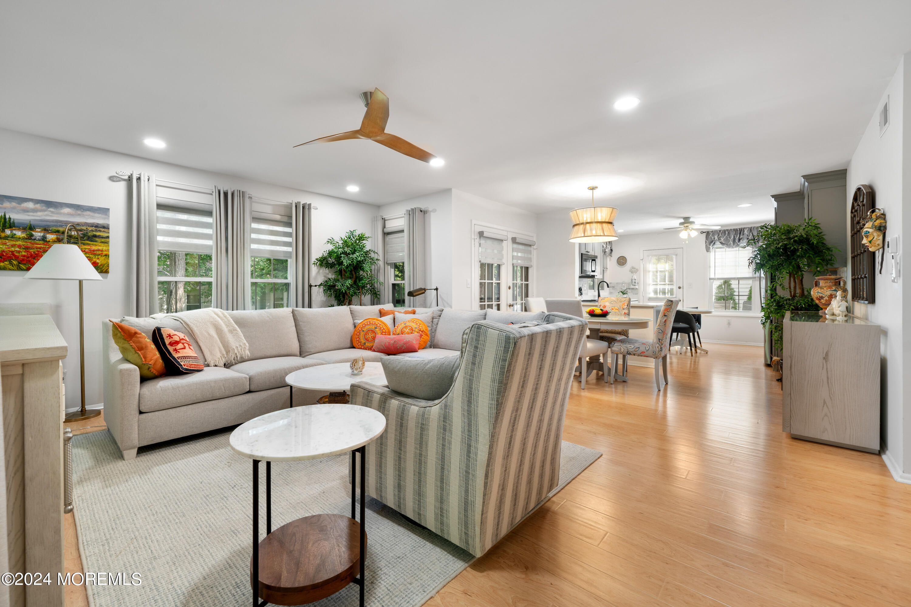 a living room with furniture a dining table and a potted plant