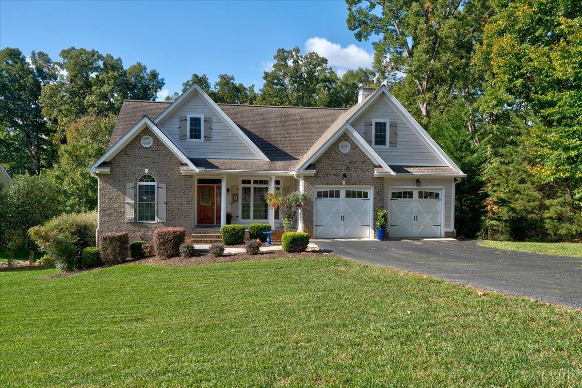 a front view of a house with a yard and trees