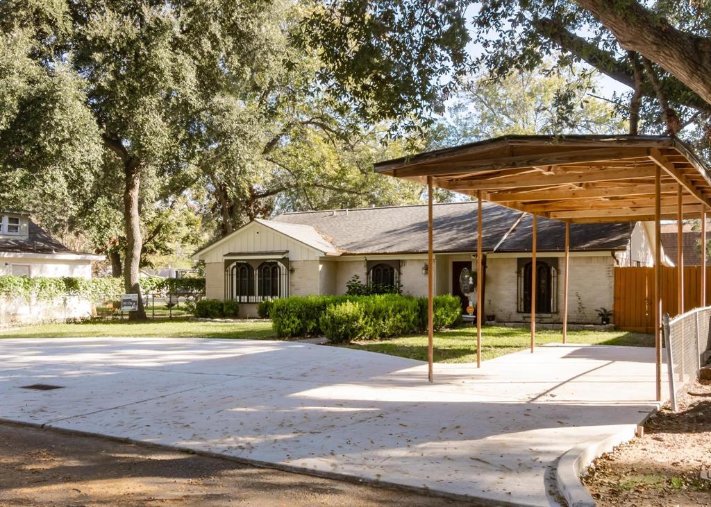 a patio with a table and chairs under an umbrella