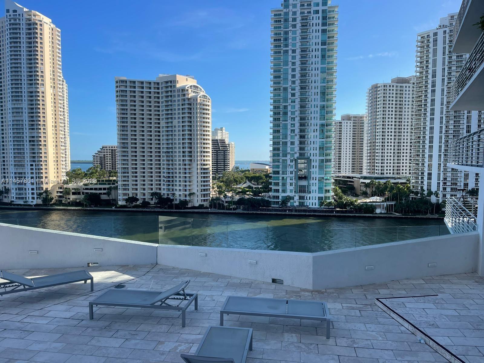 a view of a lake with tall buildings