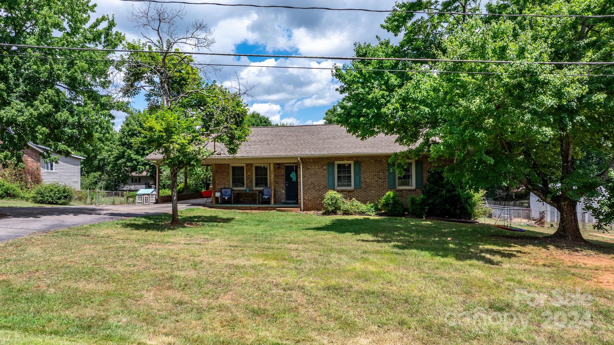 a view of a house with a yard porch and sitting area