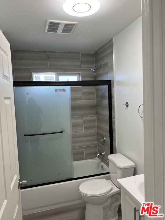 a bathroom with a toilet a sink and shower