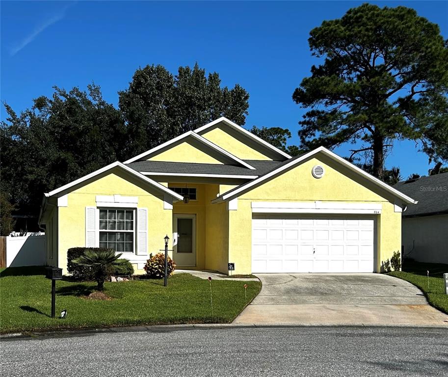 a view of a big house with a large trees and yard