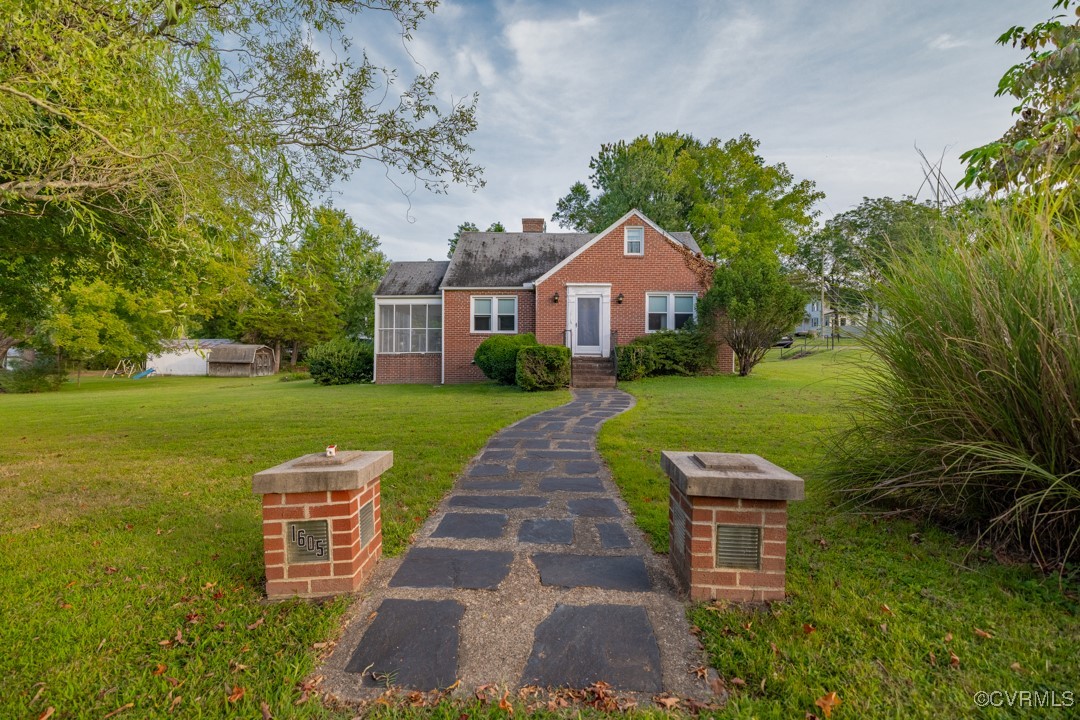 a front view of a house with garden