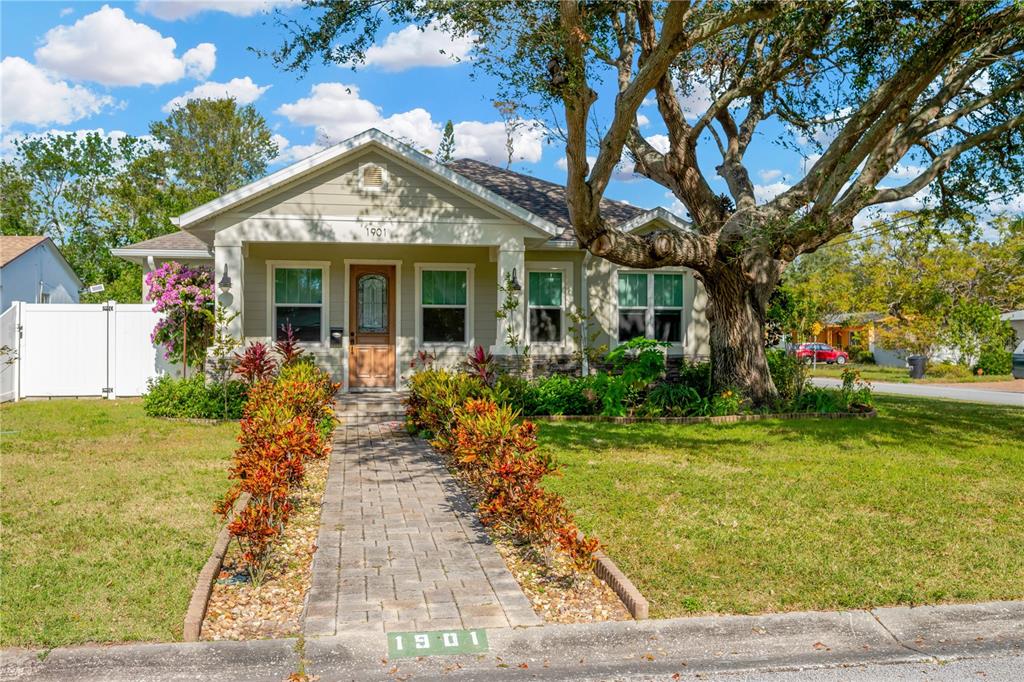 a front view of house with yard space and trees around