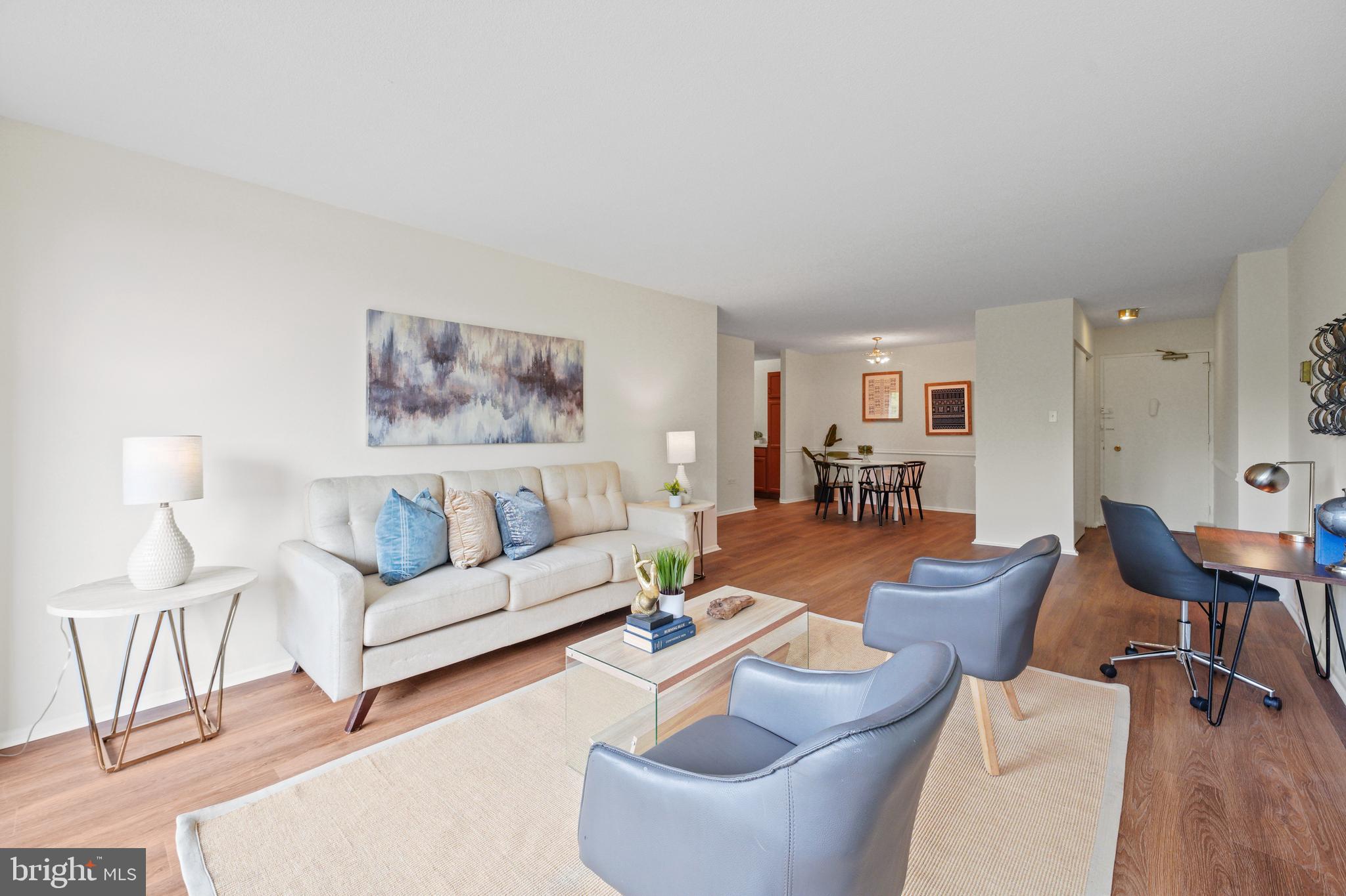 a living room with furniture dining area and a lamp