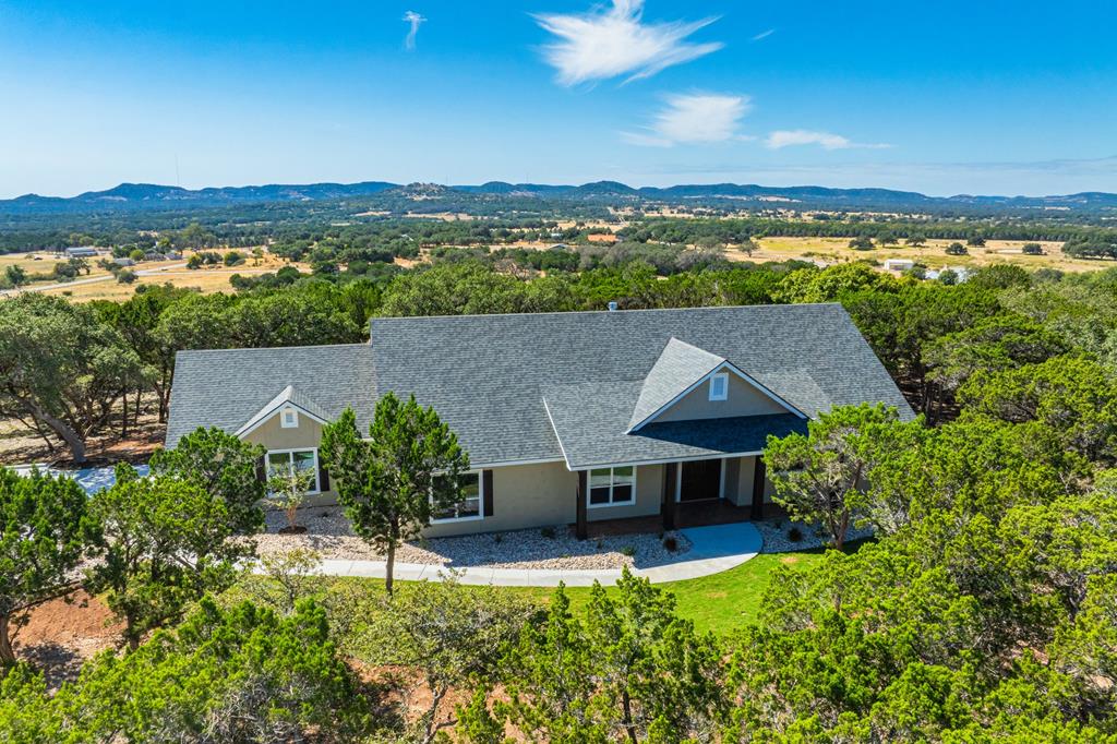 an aerial view of a house with pool lake view and mountain view