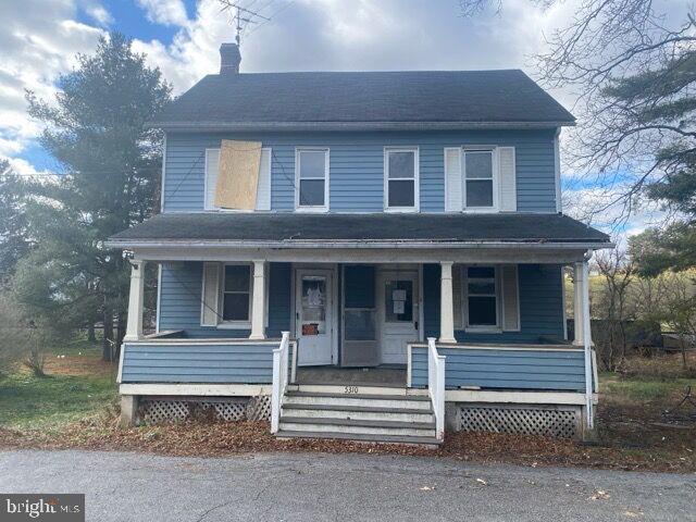 a view of a house with a window and wooden fence