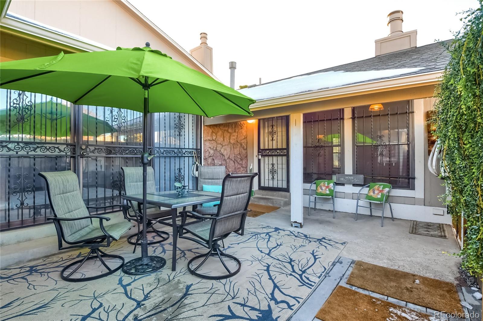 a view of table and chairs under an umbrella in patio