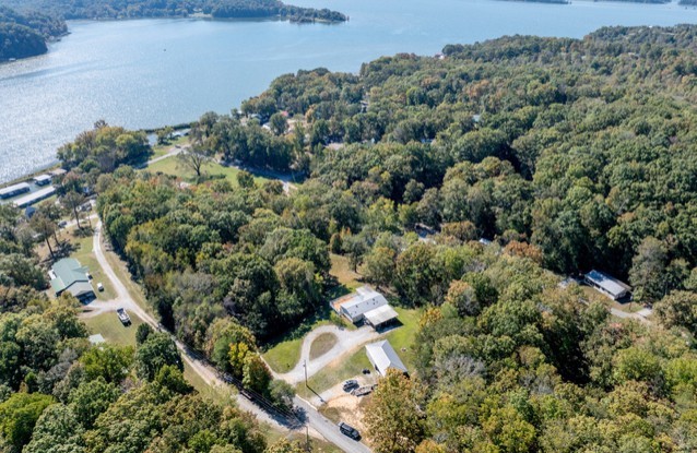 an aerial view of a house with a yard and lake view