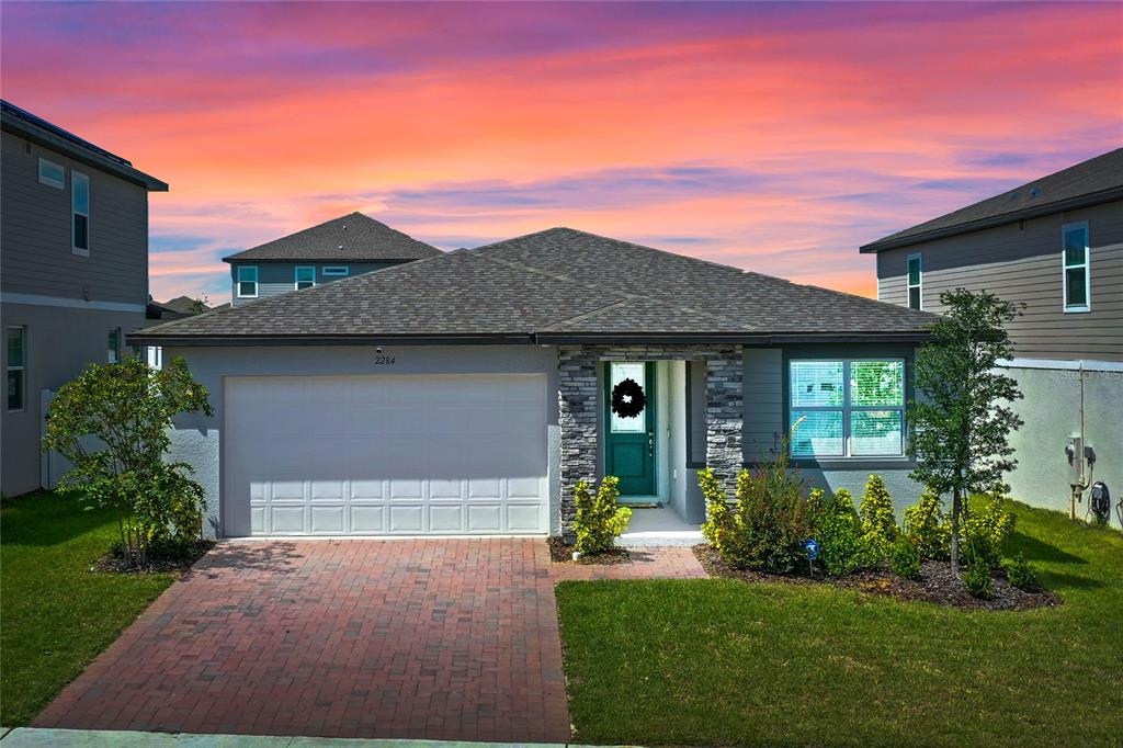 a front view of a house with a yard