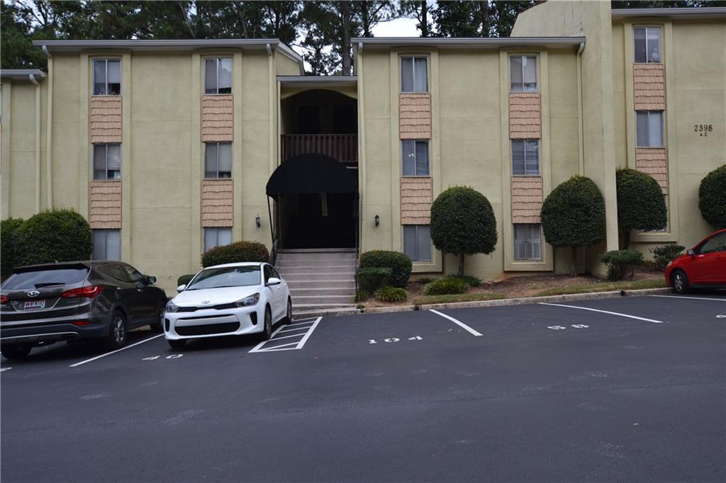 a couple of cars parked in front of a house