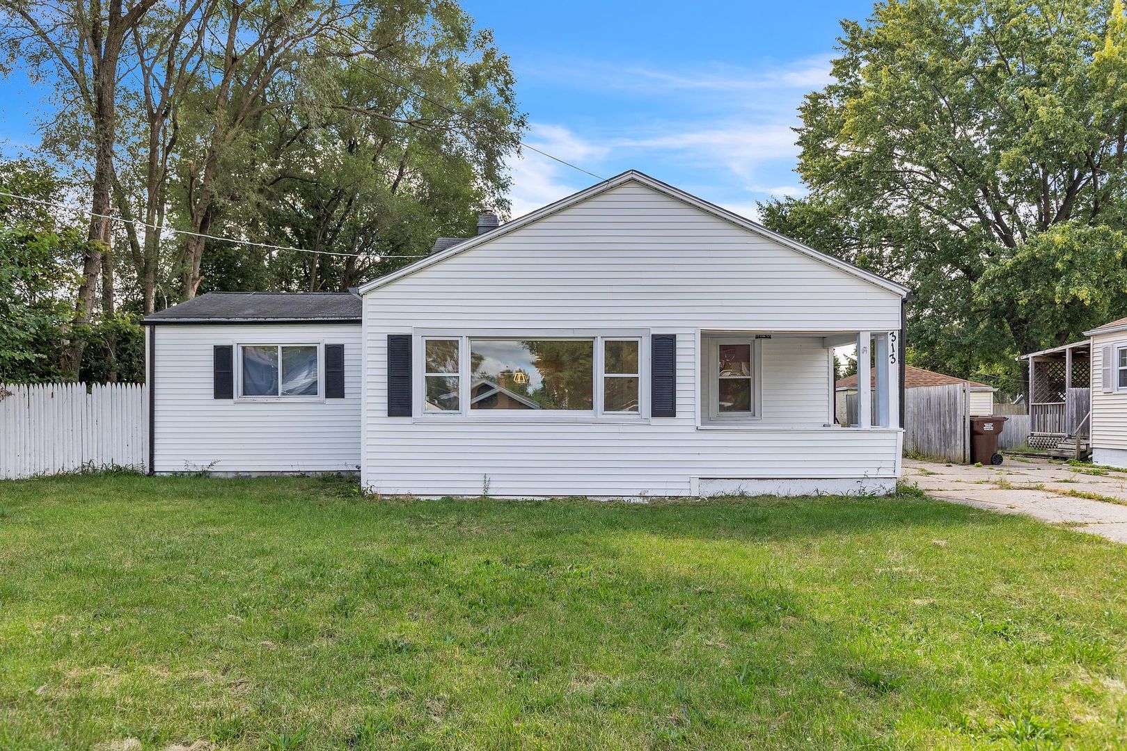 a view of a house with a yard and a garden