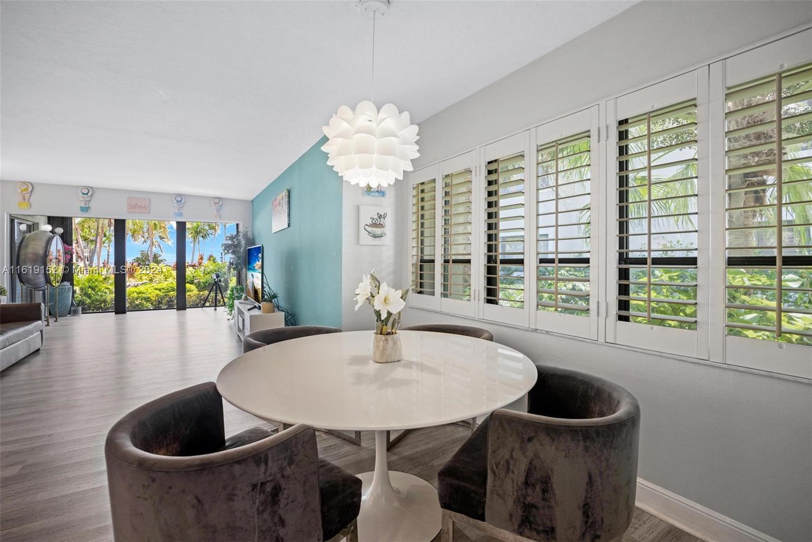 a dining room with furniture and wooden floor