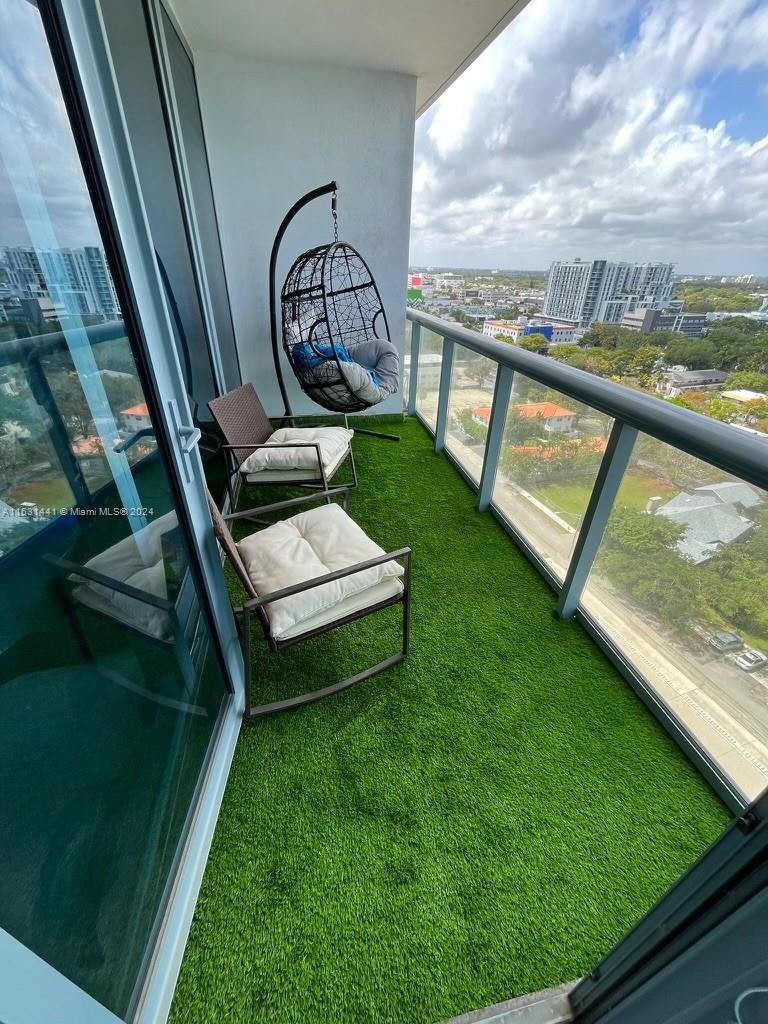 a view of a two chairs in the balcony