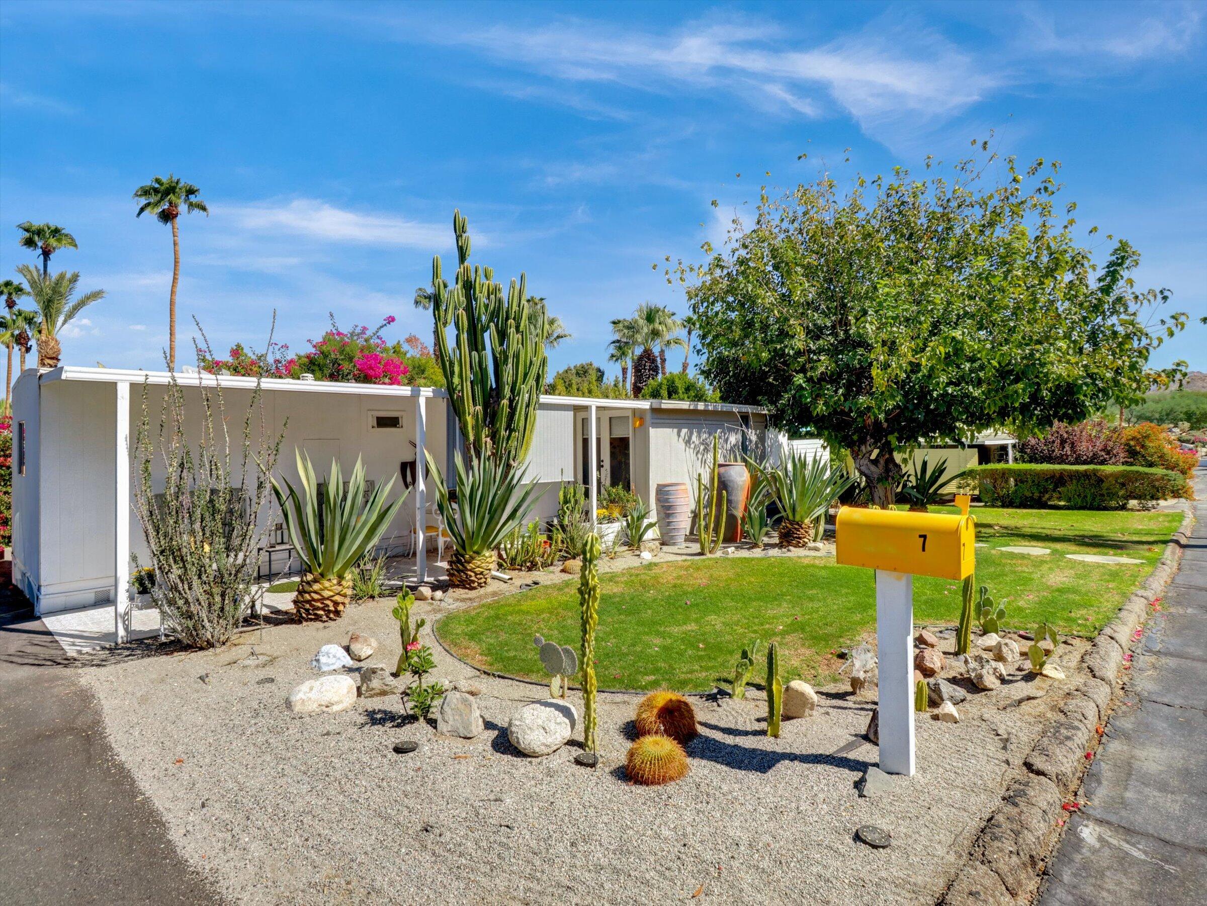 an outdoor view of a house with garden