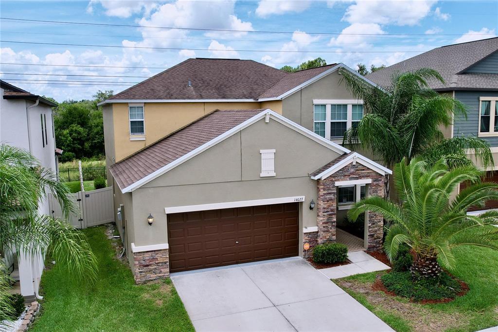 a front view of a house with a garden