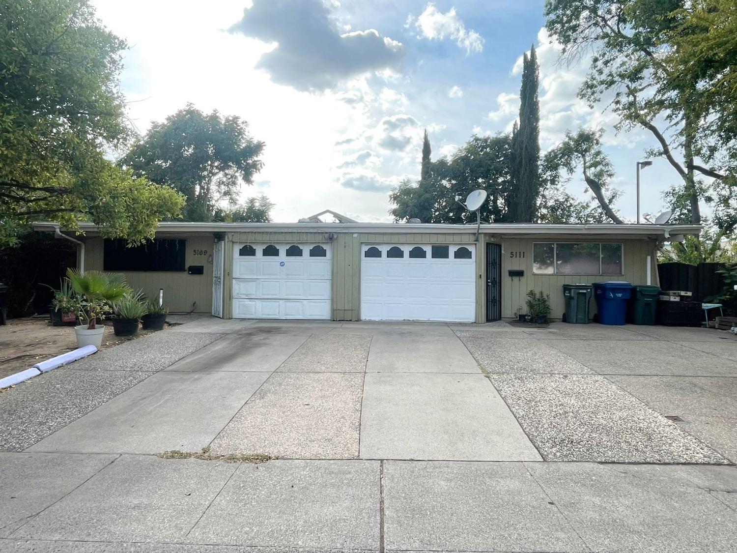 a front view of a house with a yard and a garage