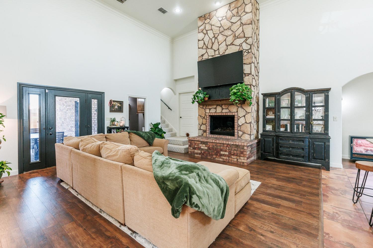 a living room with furniture a flat screen tv and a fireplace