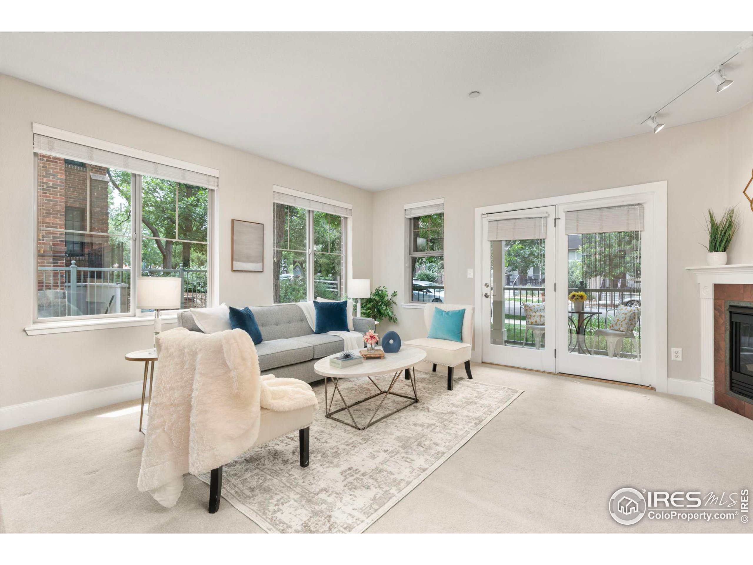 a living room with furniture and large windows