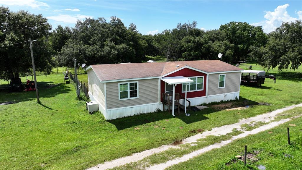 a aerial view of a house with a yard table and chairs