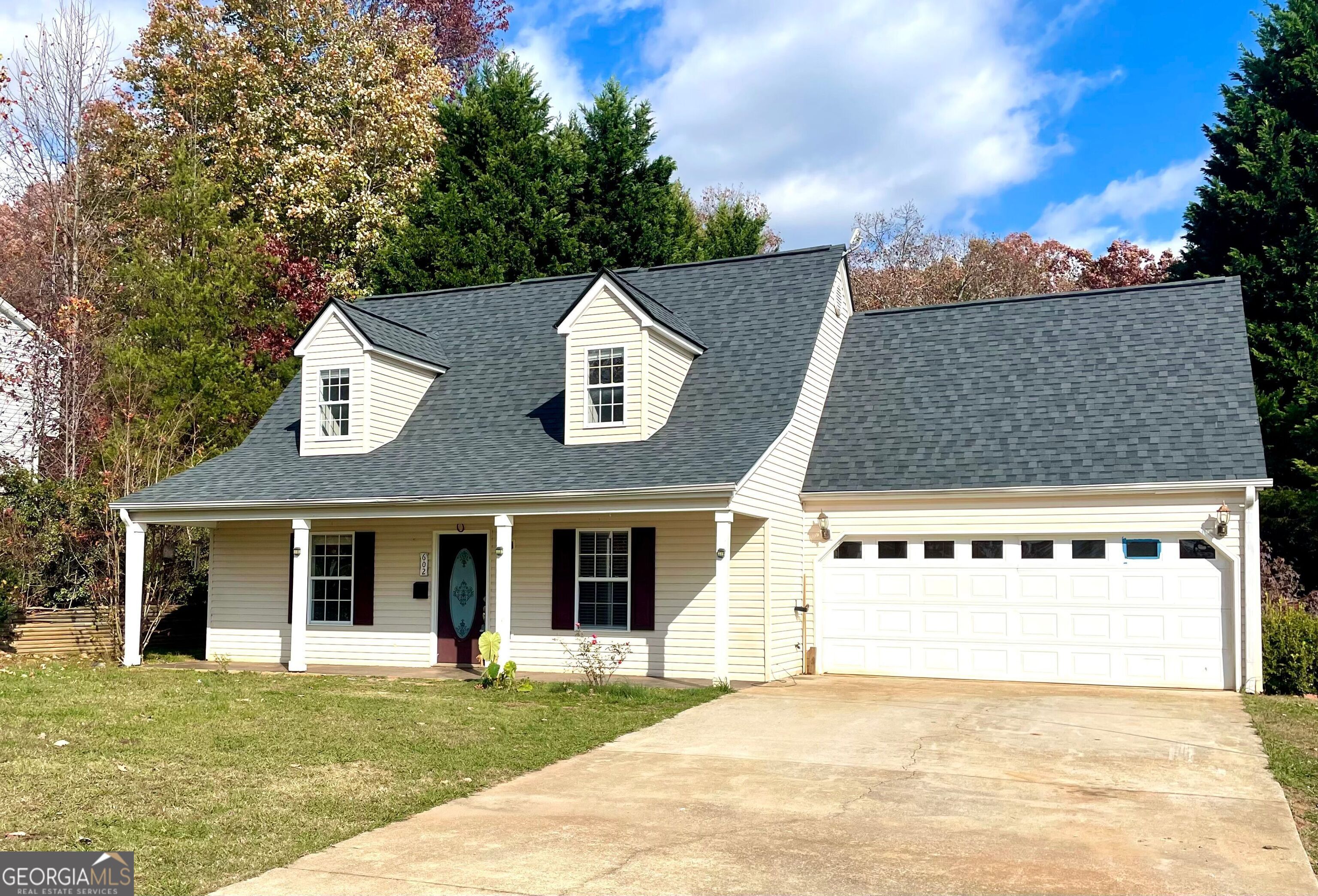 a front view of a house with a yard