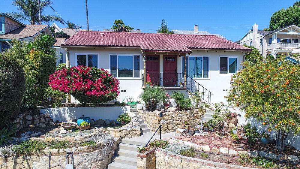 a front view of a house with a garden