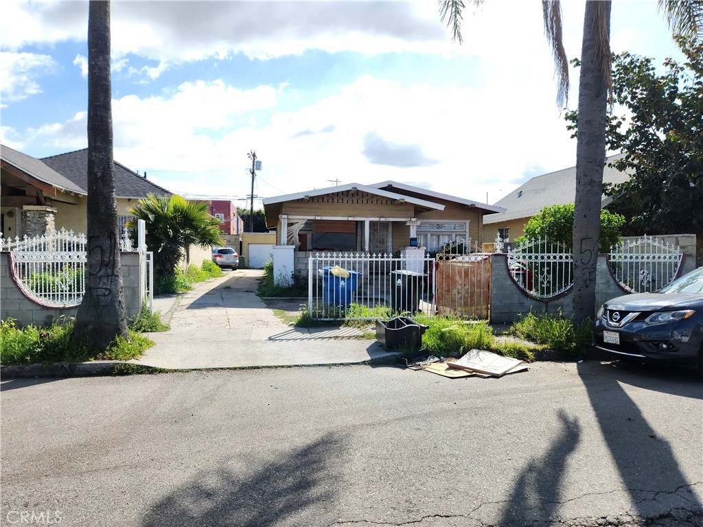 a front view of a house with a garden and mountain view