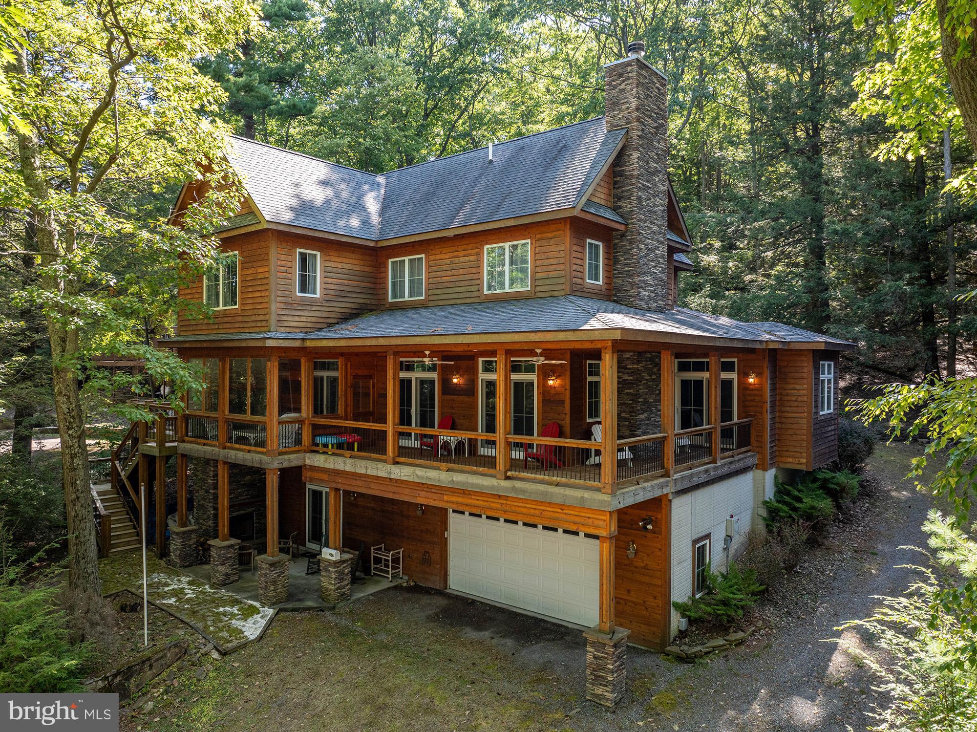 a front view of a house with a yard garage and outdoor seating