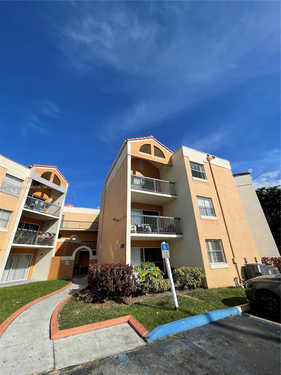 a front view of a residential apartment building with a yard