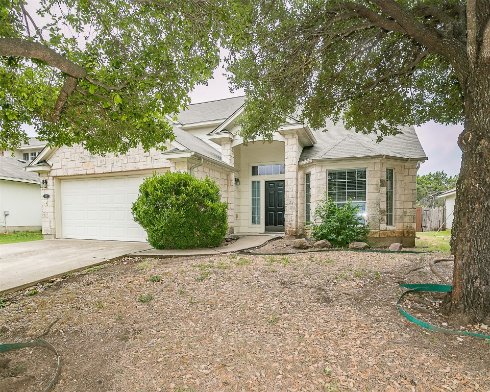 a front view of a house with a yard and a garage