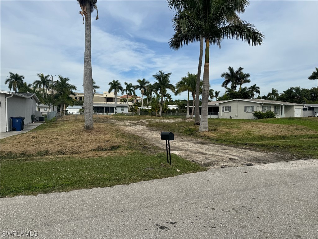 a view of a yard with cars