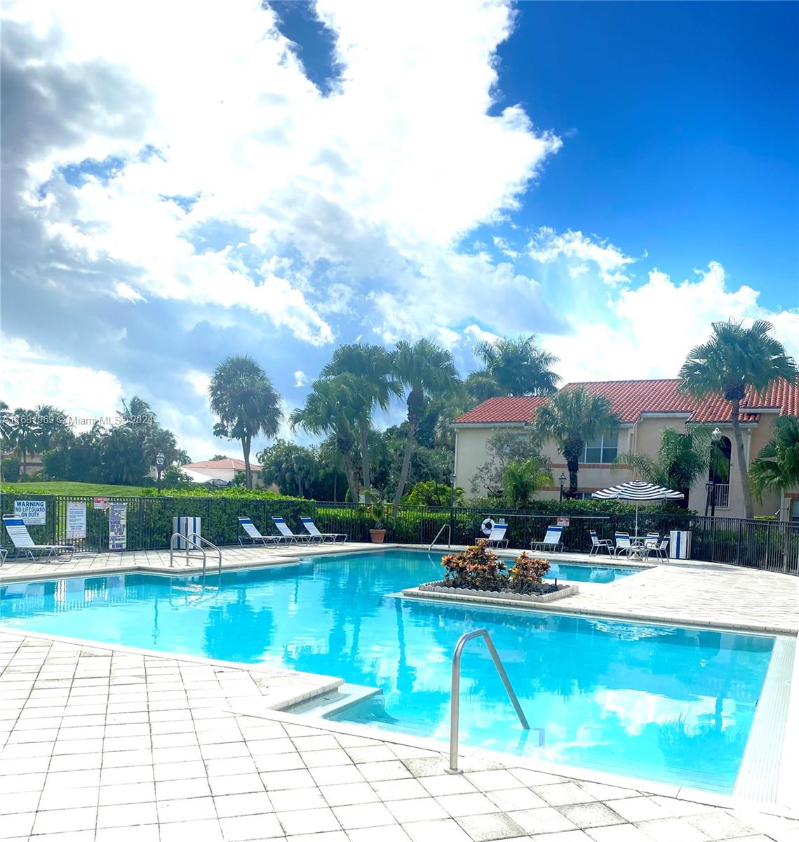 a swimming pool with outdoor seating and garden