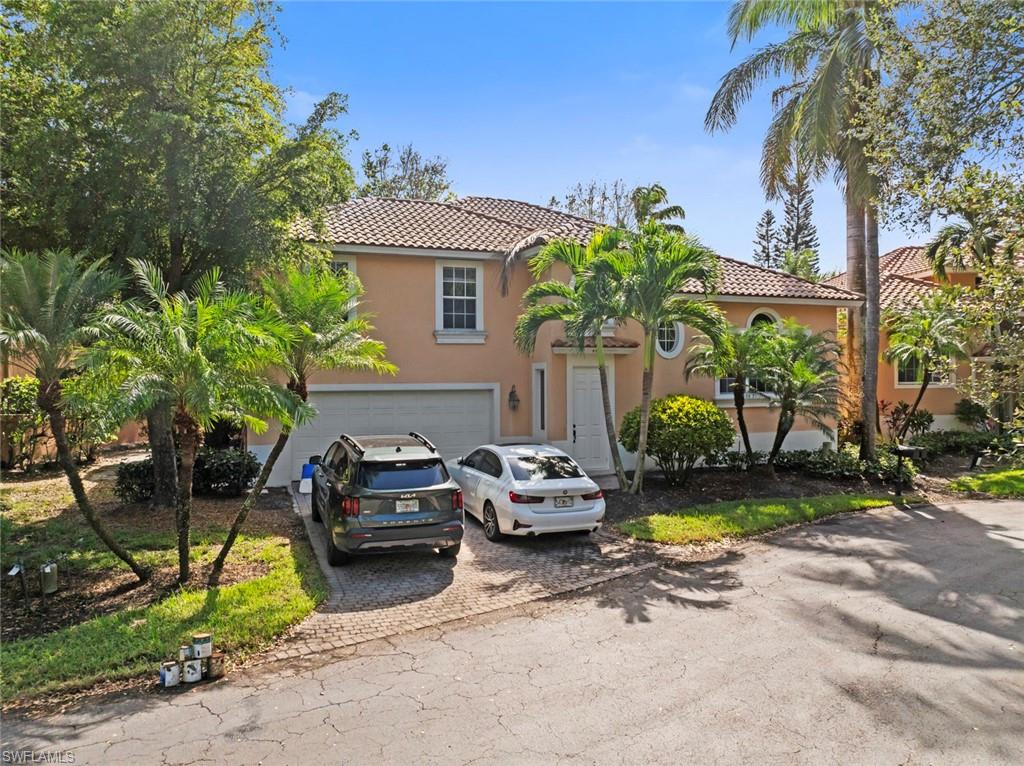 a front view of a house with garden and sitting area