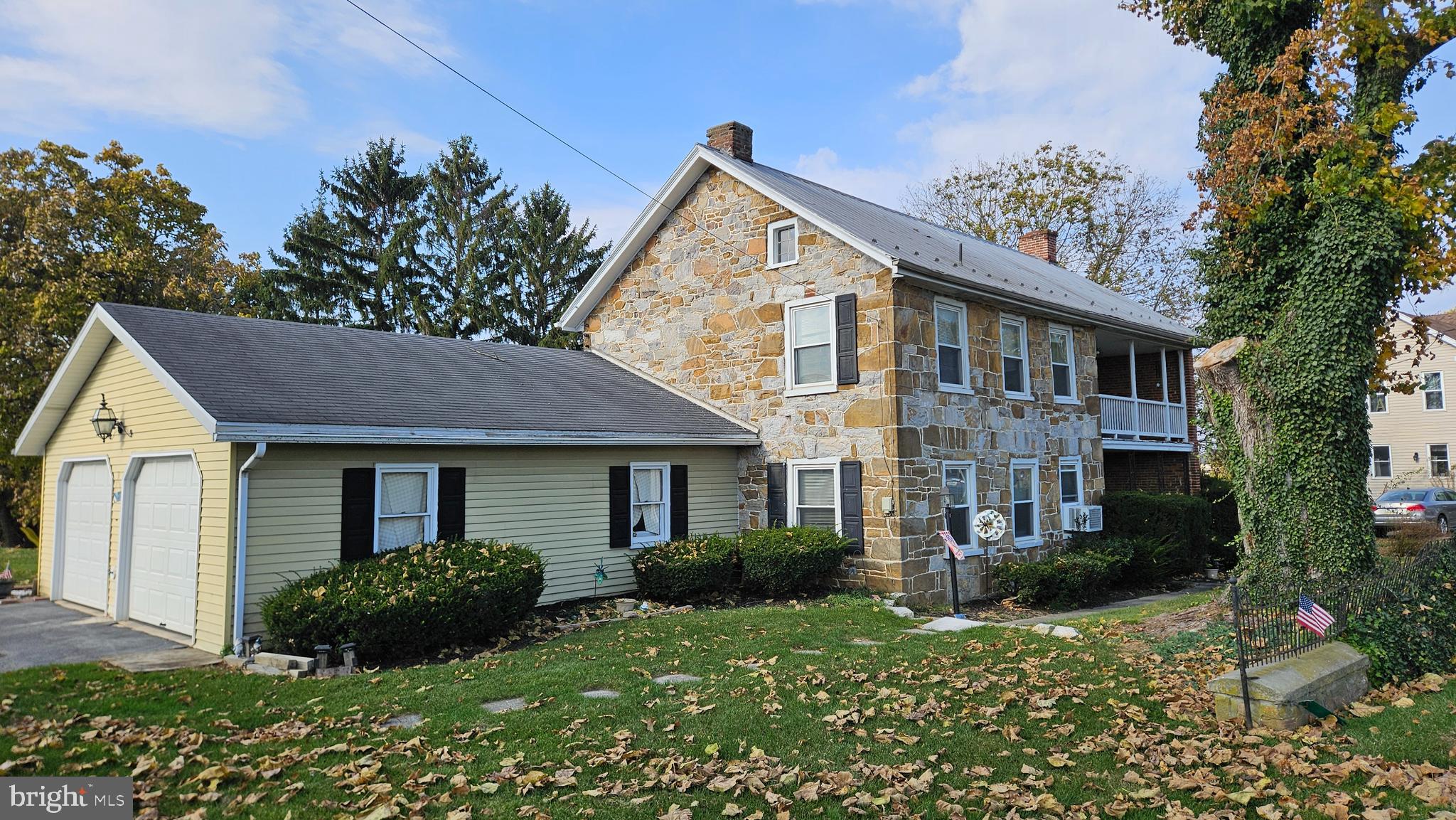 a front view of a house with a yard and potted plants