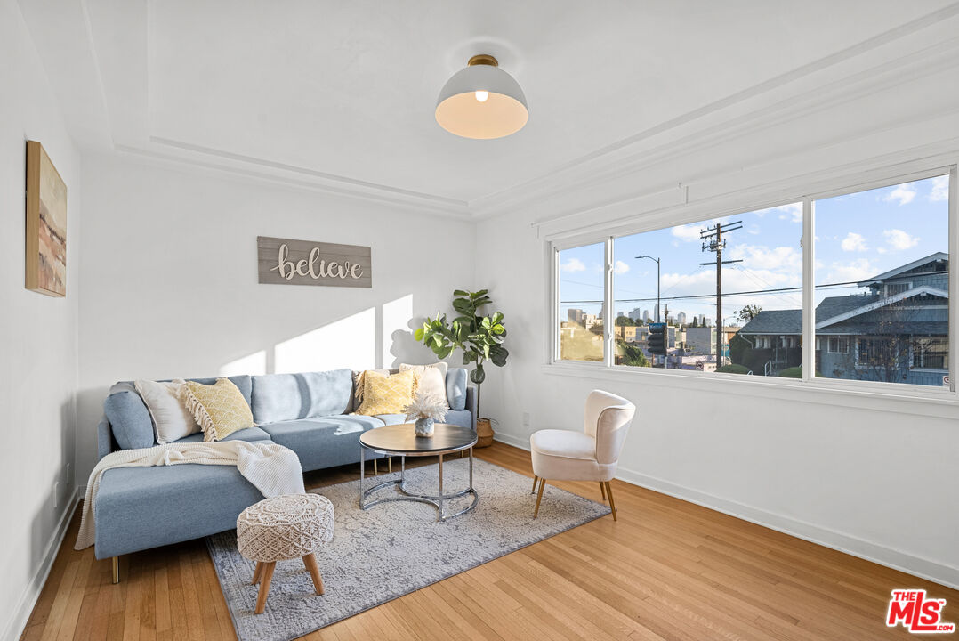 a living room with furniture and wooden floor