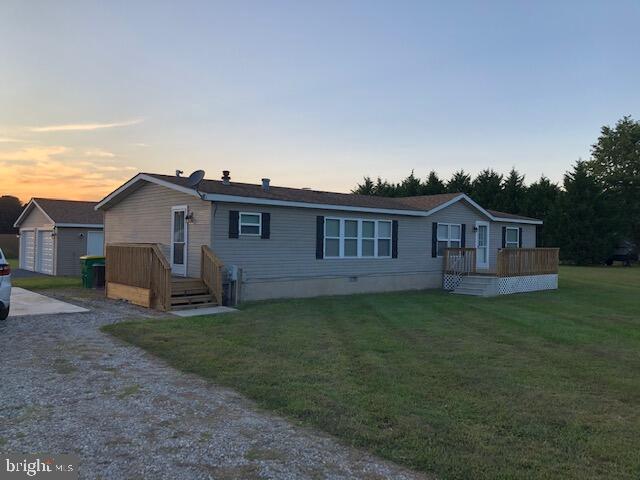 a view of a house with a yard and deck