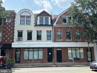 a view of a brick house with large windows