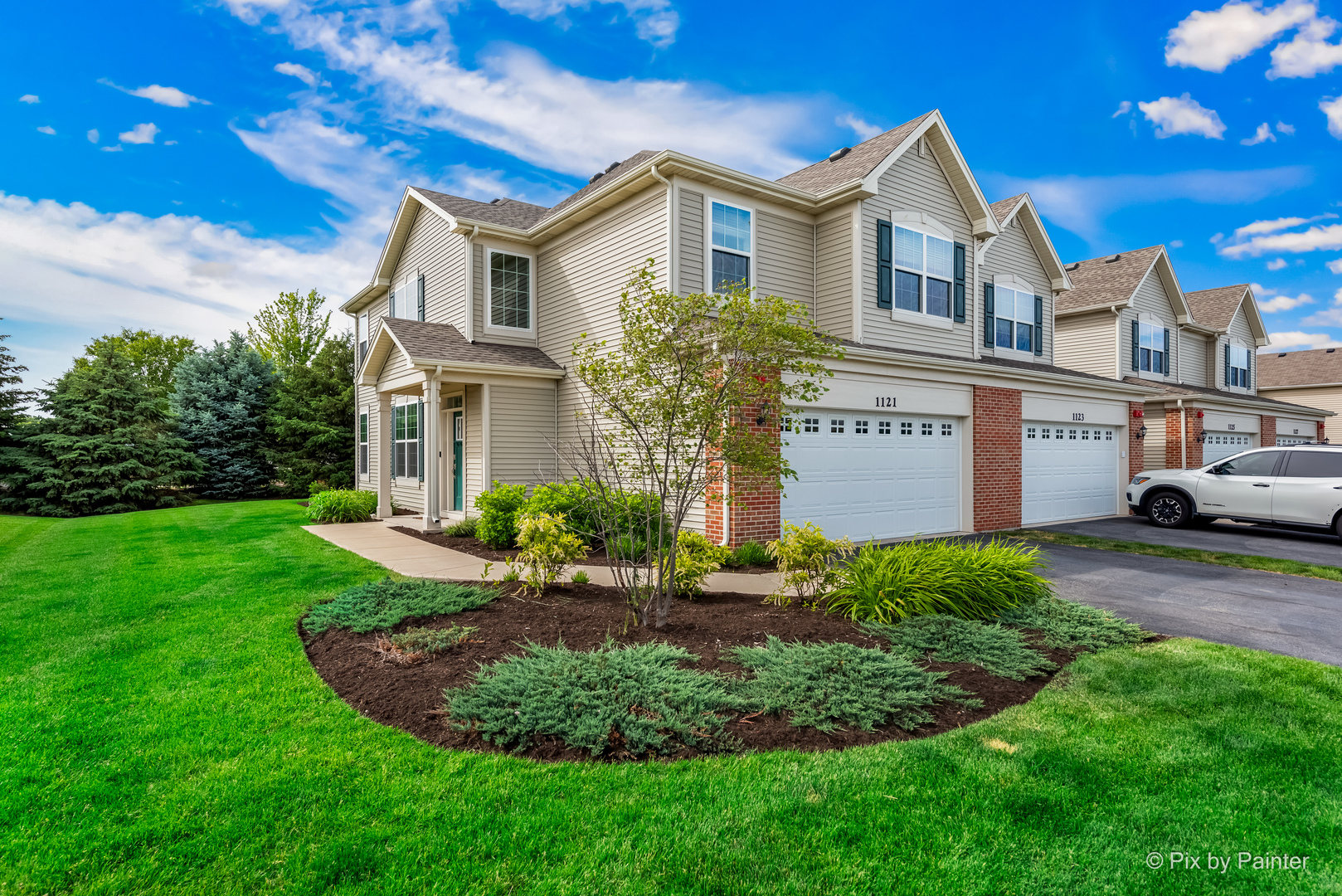 a front view of a house with a yard and garage