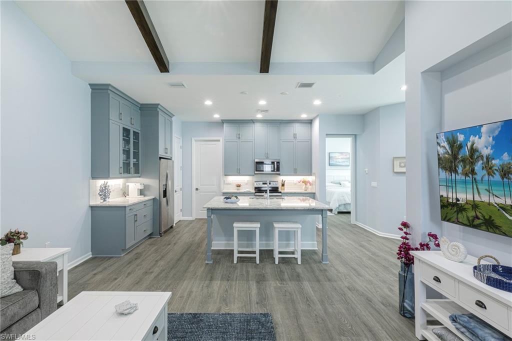 a dining room with a table chairs and a kitchen view