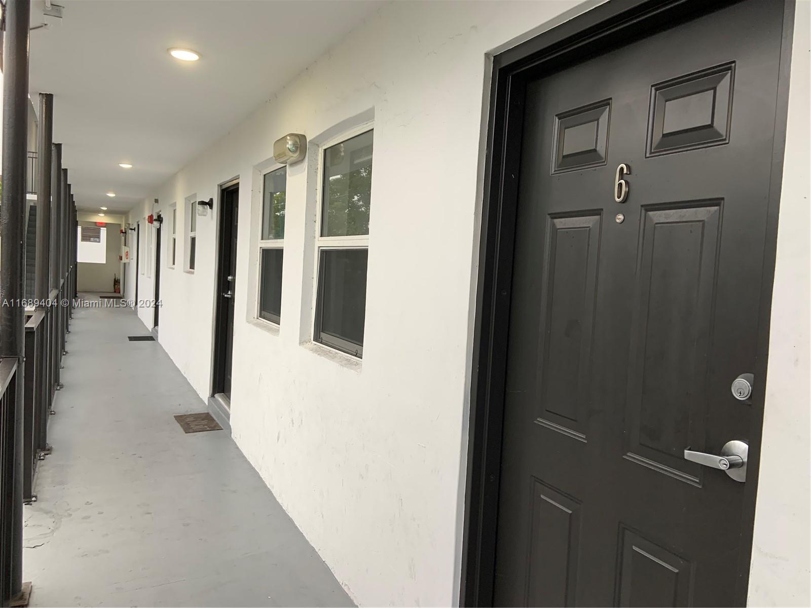 a view of a hallway with wooden shelves