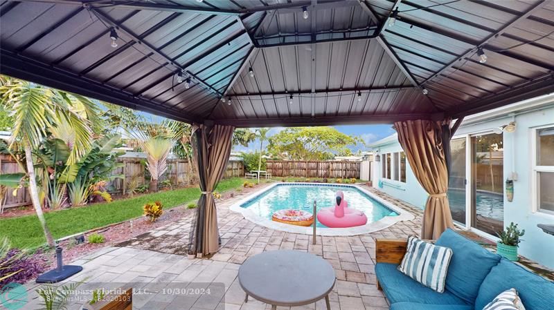 Backyard private patio and pool area with gazebo