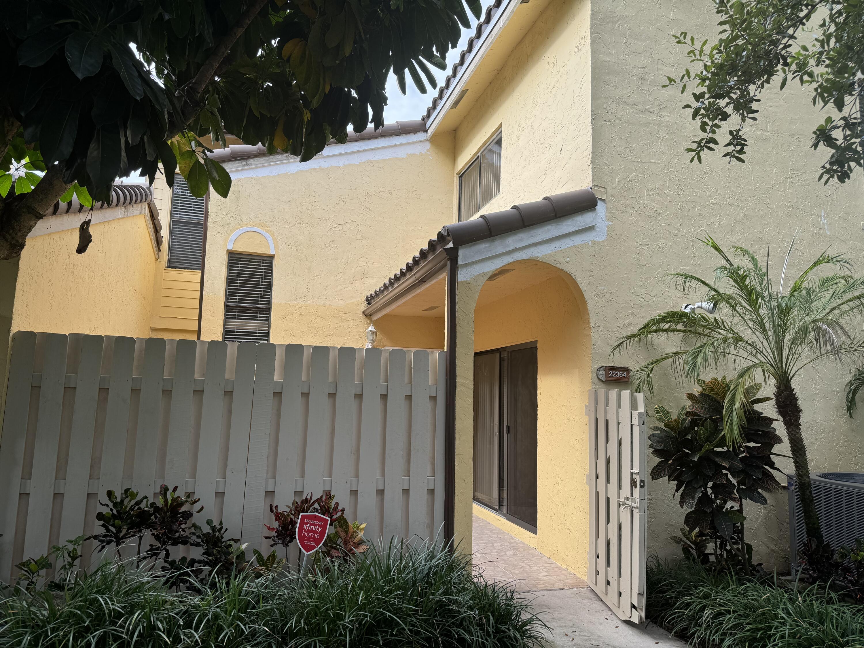 a view of a house with a flower garden