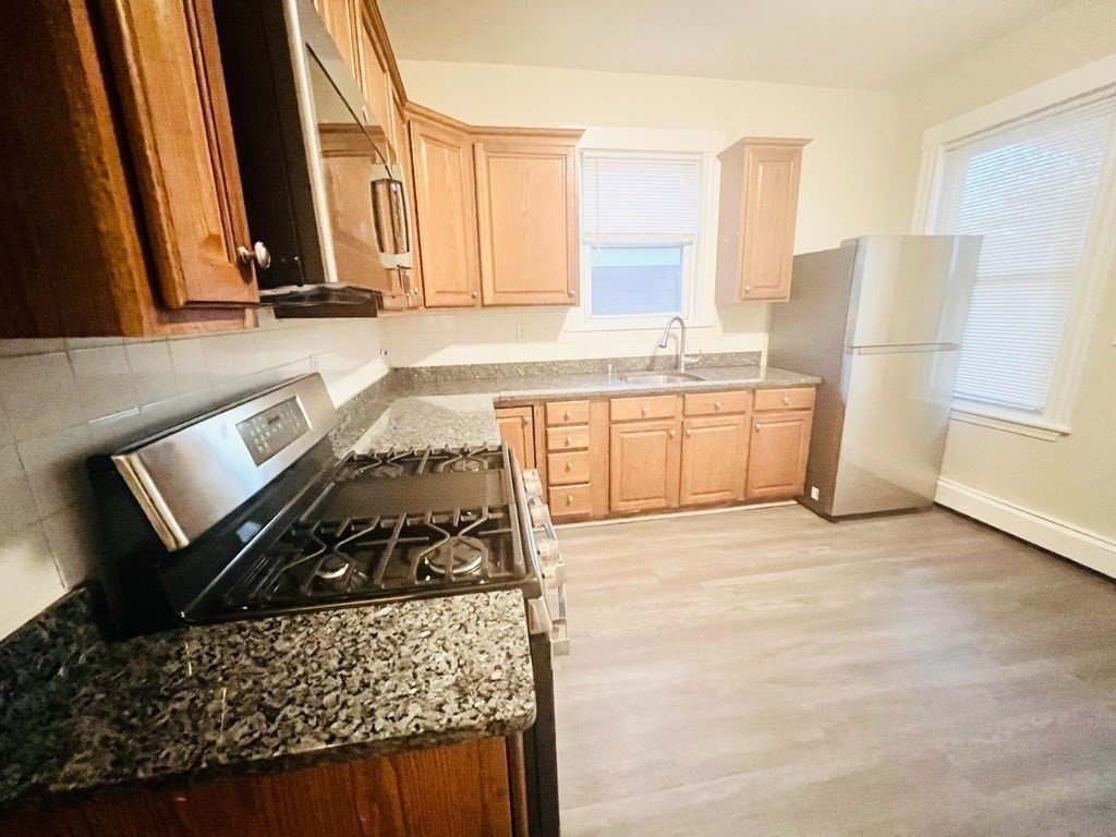 a kitchen with a stove a refrigerator and a stove