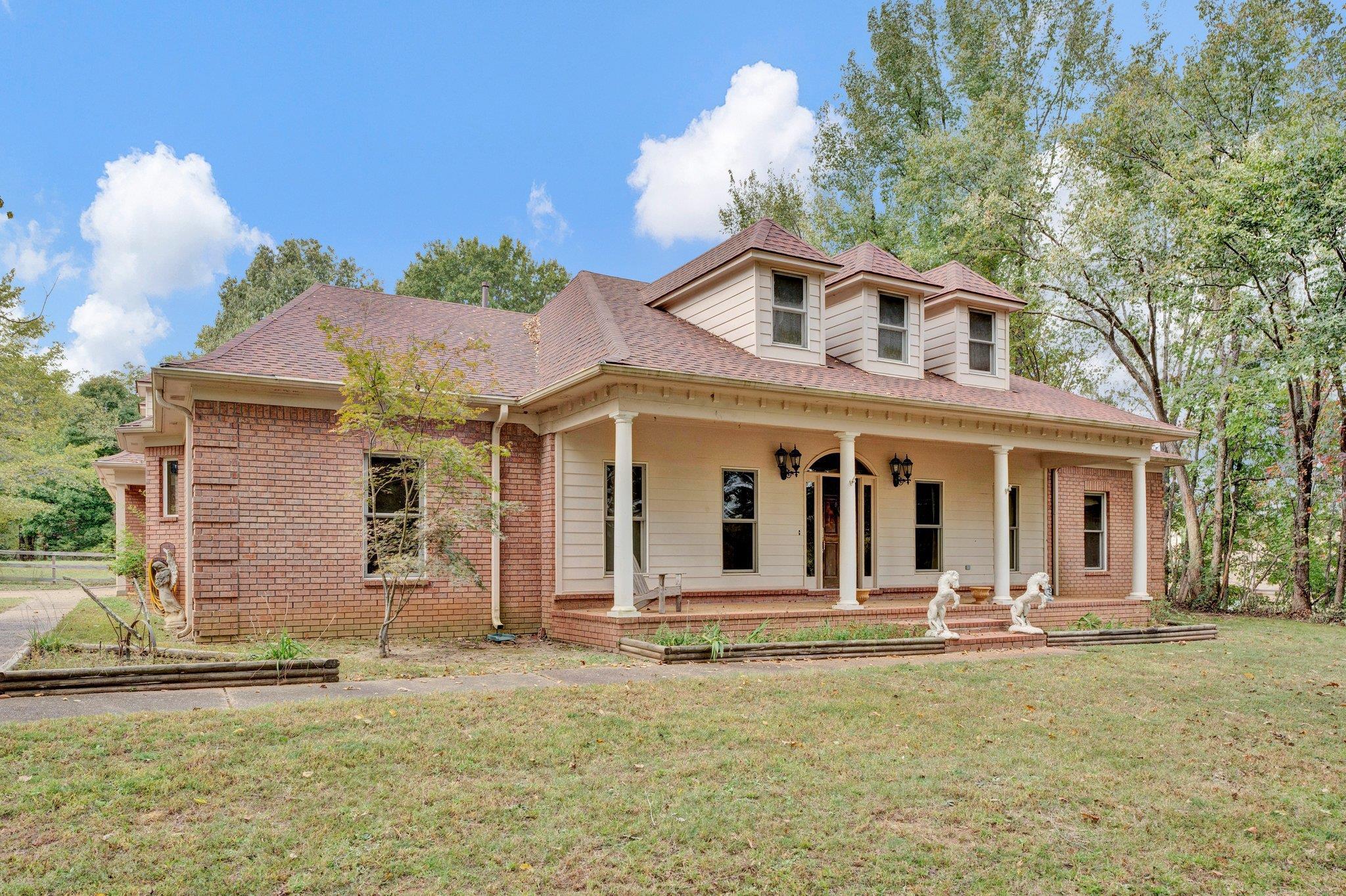 View of front facade featuring a porch and a front lawn