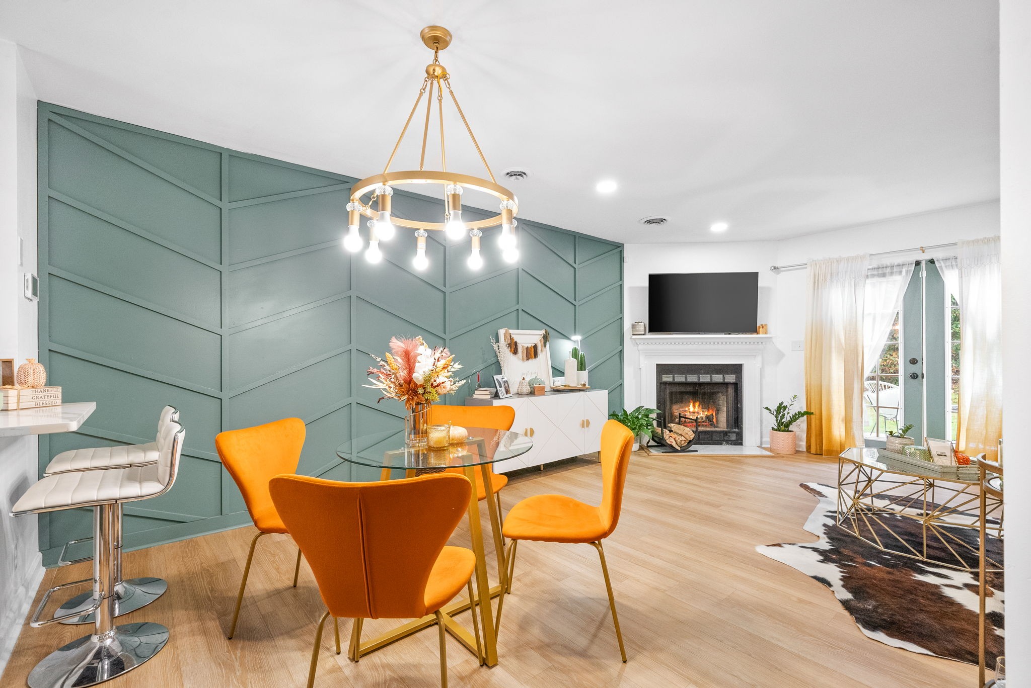 a living room with furniture a fireplace and a chandelier