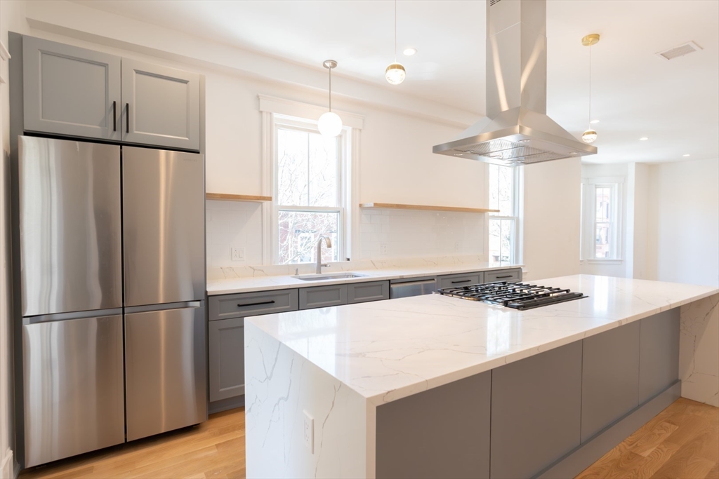 a kitchen with stainless steel appliances a sink and a refrigerator