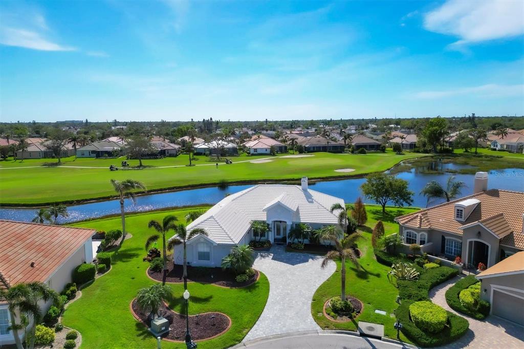 an aerial view of a house with garden space and outdoor seating