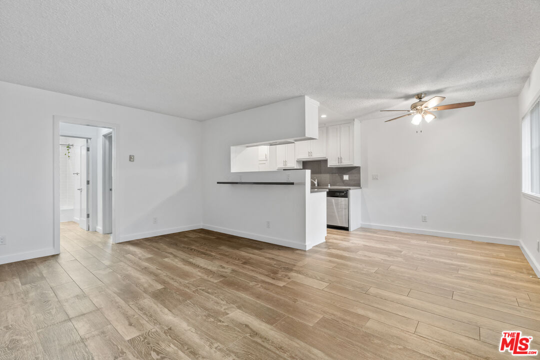 a view of a kitchen with a stove cabinets and wooden floor